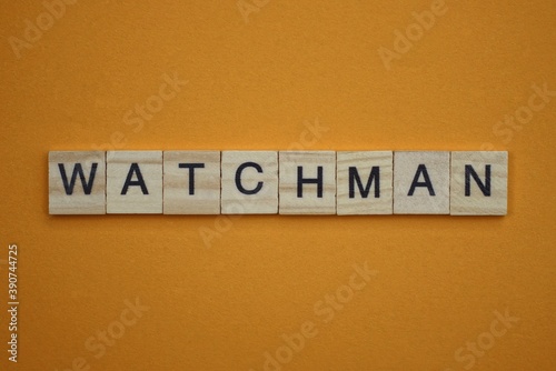 gray word watchman made of wooden square letters on brown background © butus