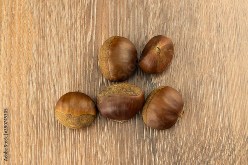 heap brown chestnut peeled on a wooden board street snack in europe