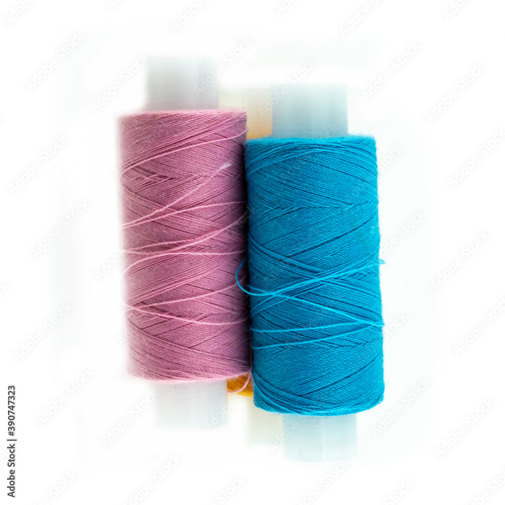 pair of vertical spools of thread blue and orange embroidery material pair of vertical spools of thread blue and orange embroidery material
