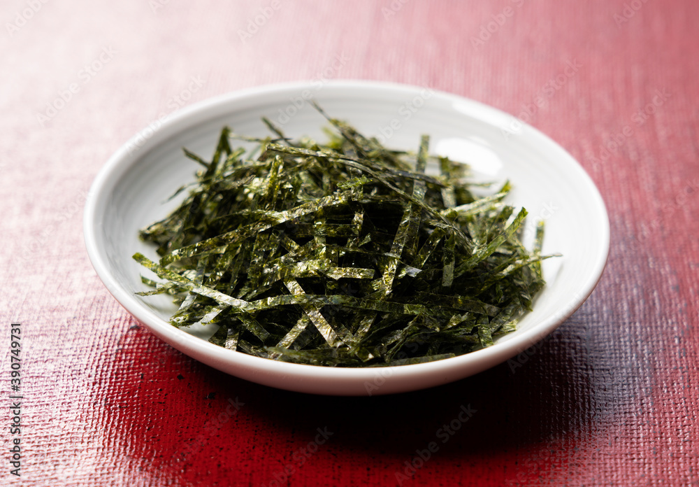 Chopped seaweed on a red Japanese background Chopped seaweed on a red Japanese background