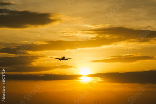 aircraft landing with sun set background
