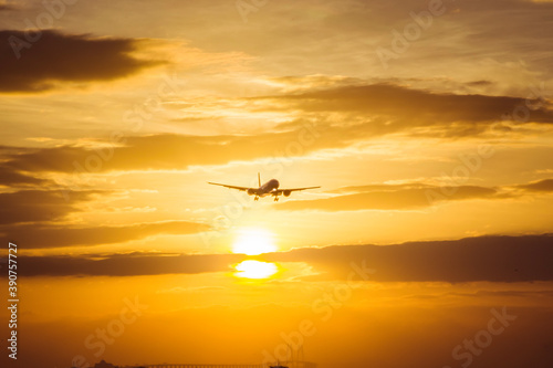 aircraft landing with sun set background © heychli