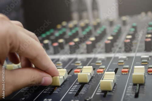 Audio mixer console and professional sound mixing with buttons and sliders.