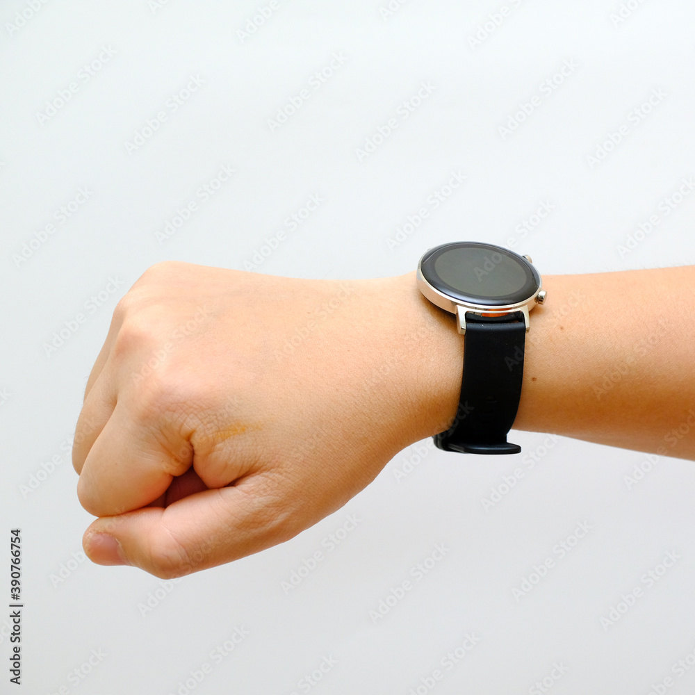 Fototapeta premium Human hand wearing smart watch with blank screen, white background cutout. modern digital gadget with empty display, copy space for text, Wearable gadget concept