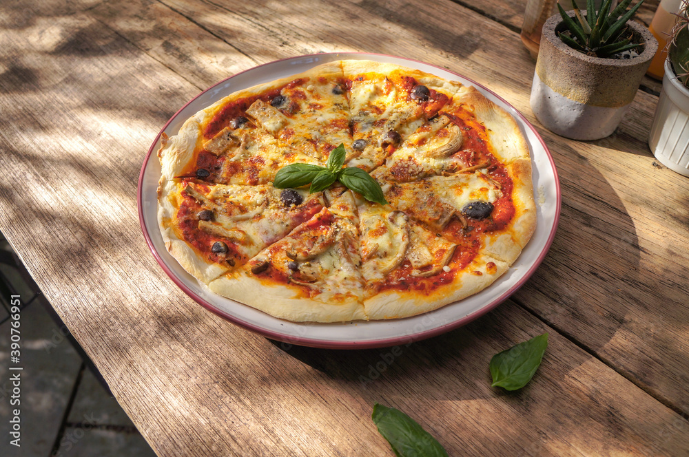 Ham and cheese pizza on a wooden table