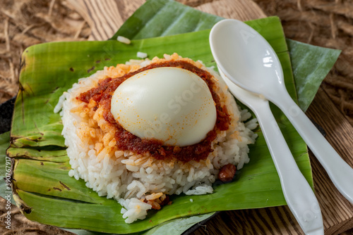 Simple Traditional popular Malaysian Nasi Lemak served on a banana leaf
