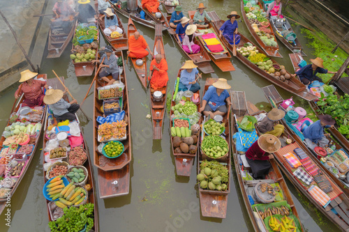 Damnoen Saduak Floating Market or Amphawa. Local people sell fruits, traditional food on boats in canal, Ratchaburi District, Thailand. Famous Asian tourist attraction destination. Festival in Asia. photo