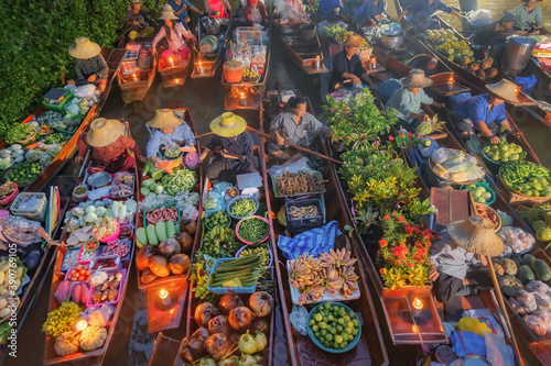 Damnoen Saduak Floating Market or Amphawa. Local people sell fruits, traditional food on boats in canal, Ratchaburi District, Thailand. Famous Asian tourist attraction destination. Festival in Asia.