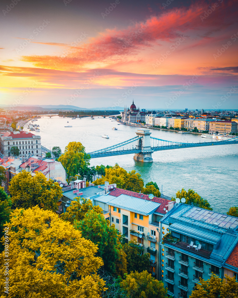 Scenic top view of the Hungarian Parliament and Chain Bridge on the Danube river at sunset.