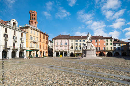 Beautiful square in an old city in Italy. Historic center of Vercelli. Square Cavour with the monument to Cavour of 1864 and the Angel tower (14th-17th century), symbol of the city  photo