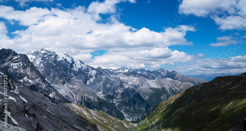 Summer Stelvio pass with alpine road and snow on slope. Panoramic view of the over the alps between Lombardy and Trentino. Color image. Italian mountains. © eskstock