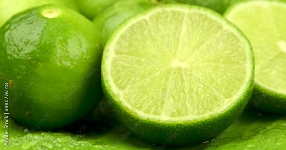 Truck shot close up of half and whole fresh lime juicy on green banana leaves with clearly water drop on surface Truck shot close up of half and whole fresh lime juicy on green banana leaves with clearly water drop on surface