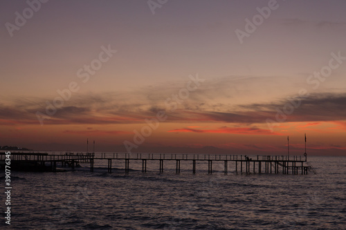 Beautiful sunset on the sea and the pier. © anya babii