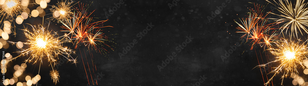 Silvester Party / New Year background banner panorama - Golden Firework and sparklers at dark black night 
