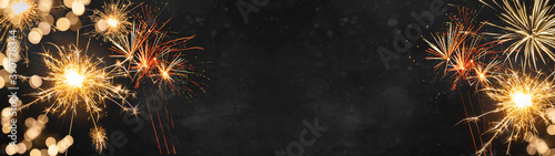 Silvester Party / New Year background banner panorama - Golden Firework and sparklers at dark black night 