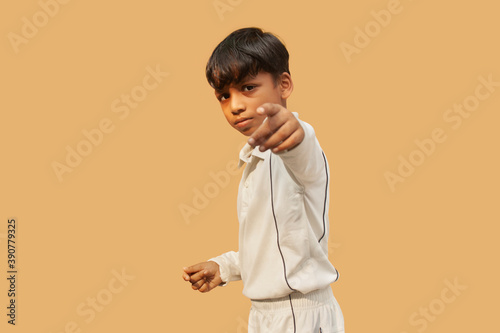 Photography A boy in cricket uniform and pointing