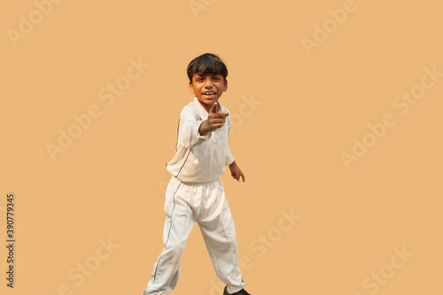 A boy celebration taking a catch During a Cricket Game