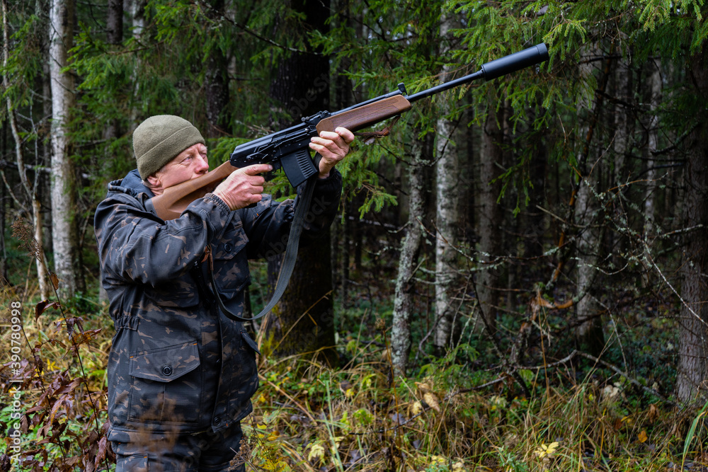 Hunter aiming a shotgun