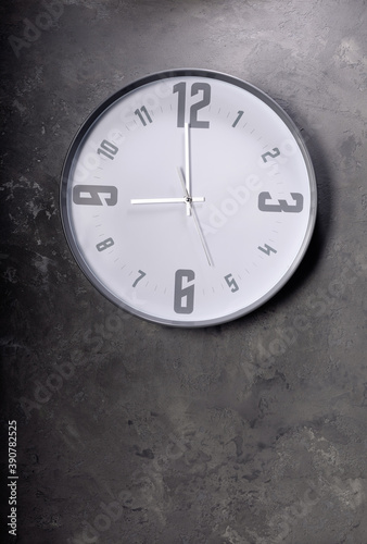 wall clock at concrete painted background