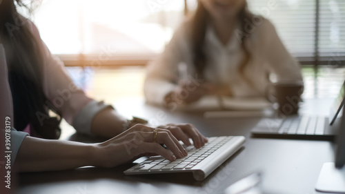 Cropped shot of businesswoman is  typing on keyboard at meeting room.