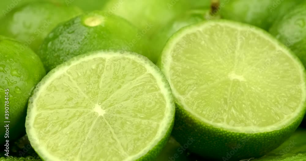 Truck shot close up of half and whole fresh lime juicy on green banana leaves with clearly water drop on surface Truck shot close up of half and whole fresh lime juicy on green banana leaves with clearly water drop on surface