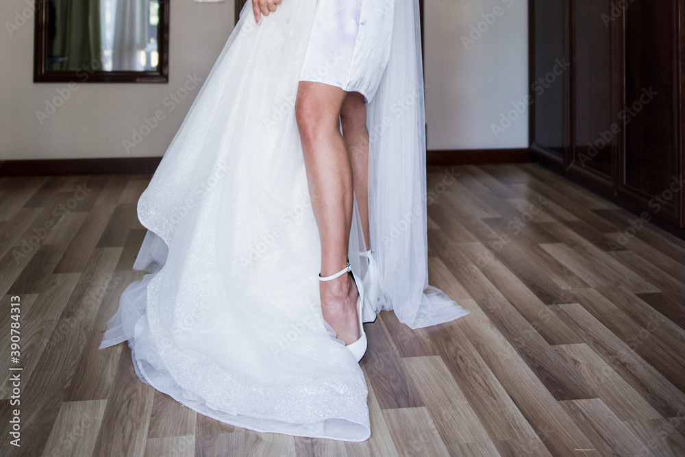 a bride in a peignoir with a wedding dress
