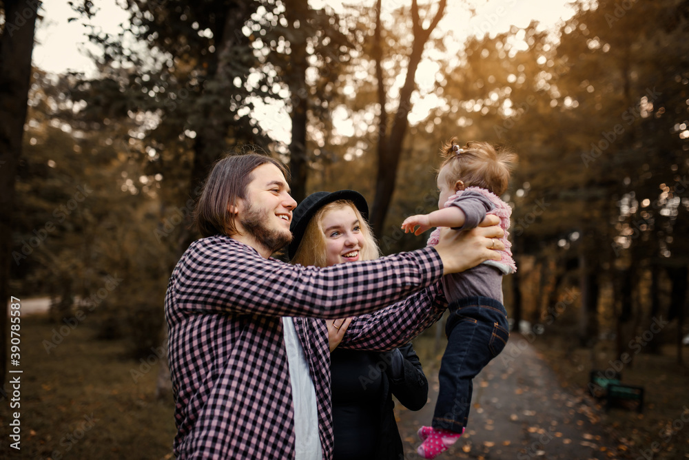 Beautiful young mother holds her baby in her hands and father is near her. Beautiful young mother holds her baby in her hands and father is near her.
