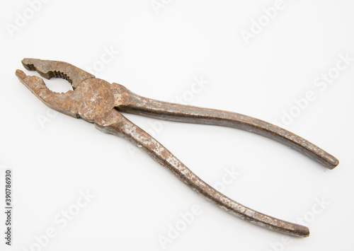 Old rusty pliers on a white background.