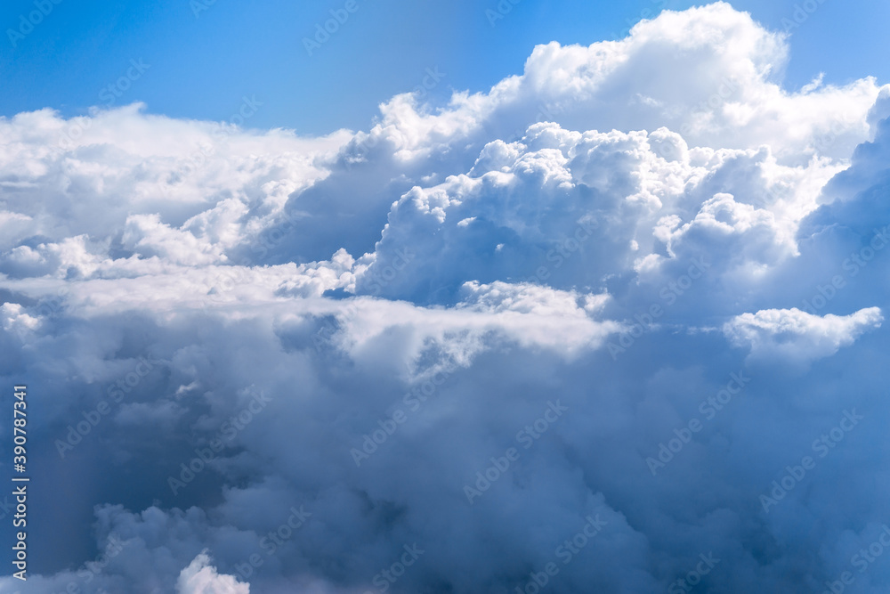 Fototapeta premium Aerial view flying above clouds in the atmosphere, depicts heaven. space for text