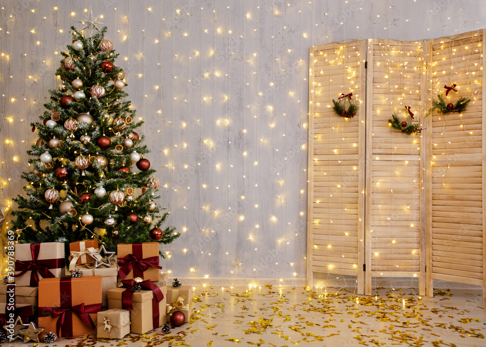 Beautiful christmas tree, gift boxes, folding screen and festive lights