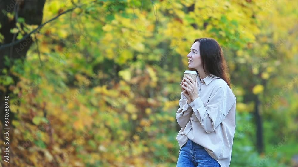 Fall concept - beautiful woman in autumn park under fall foliage Fall concept - beautiful woman in autumn park under fall foliage