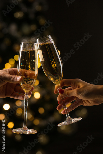 New Year concept, woman and man with champagne glasses clinking