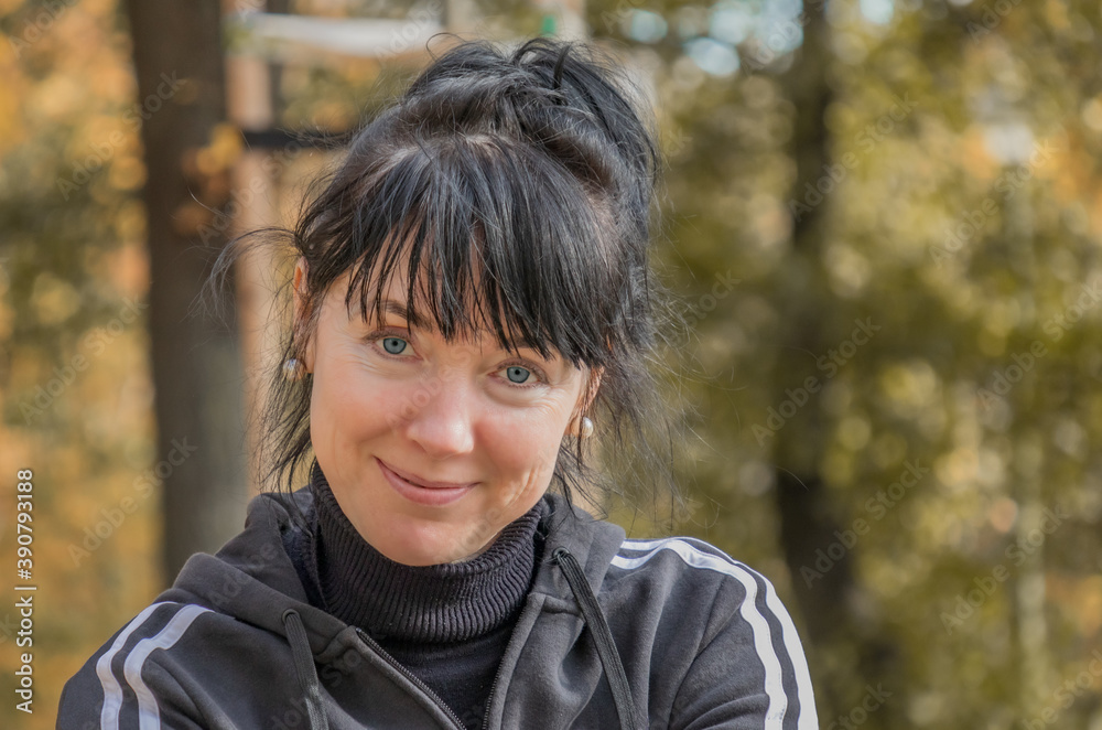 close-up portrait of an athletic beautiful European forty-year-old woman against the background of an autumn park close-up portrait of an athletic beautiful European forty-year-old woman against the background of an autumn park
