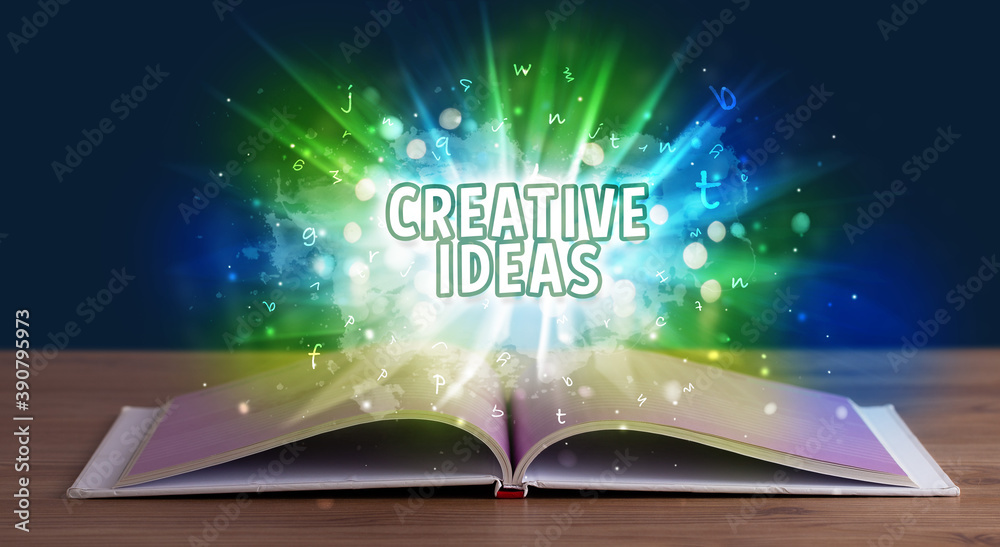 CREATIVE IDEAS inscription coming out from an open book, educational concept CREATIVE IDEAS inscription coming out from an open book, educational concept