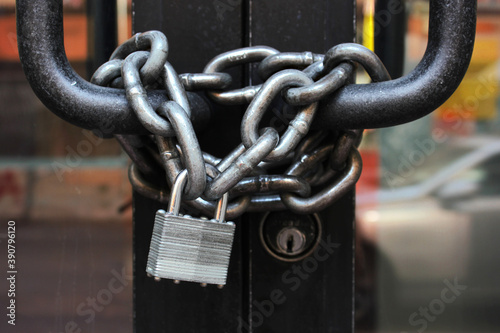 Lock with chain on a closed door. Closed on a chain with a lock a public place in the city centre.