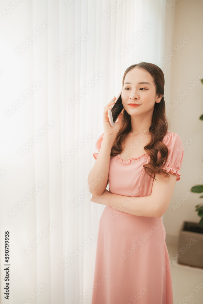 Beautiful young asian woman calling and talking with family by using mobile phone Beautiful young asian woman calling and talking with family by using mobile phone