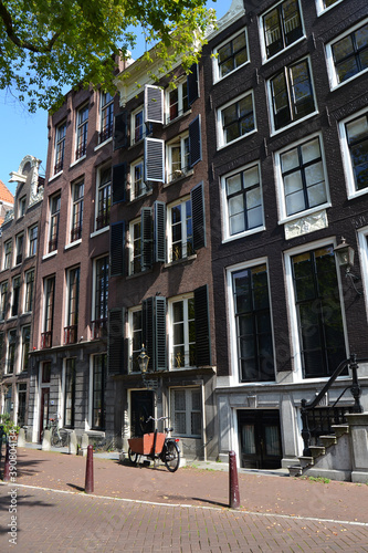 An empty street in Amsterdam, The Netherlands. Traditional dutch architecture. Vertical view