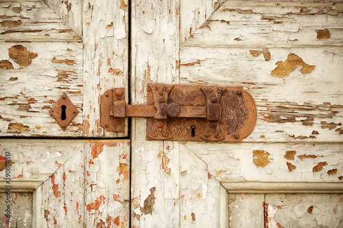 Close up detail of metal door latch on an old timber door