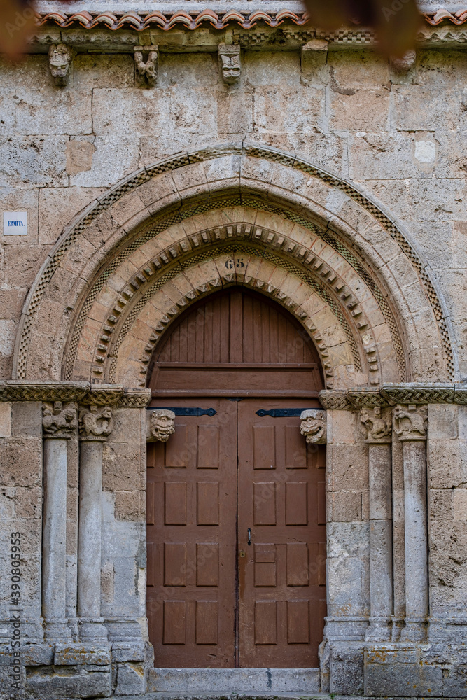 Fototapeta premium ornamental entrance, Hermitage of Nuestra Señora del Valle, Romanesque ogival temple of Byzantine influence, XII century, Burgos, Spain