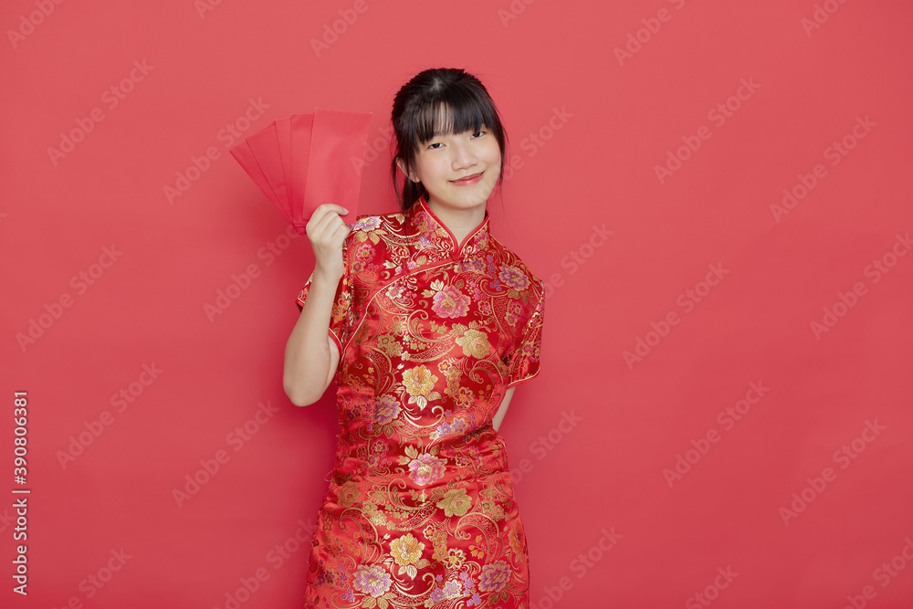 Young Asian woman wear a Chinese dress with a red envelope Young Asian woman wear a Chinese dress with a red envelope
