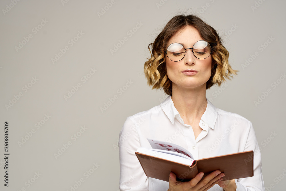 woman with notepad in hands business work beige background glasses hairstyle woman with notepad in hands business work beige background glasses hairstyle