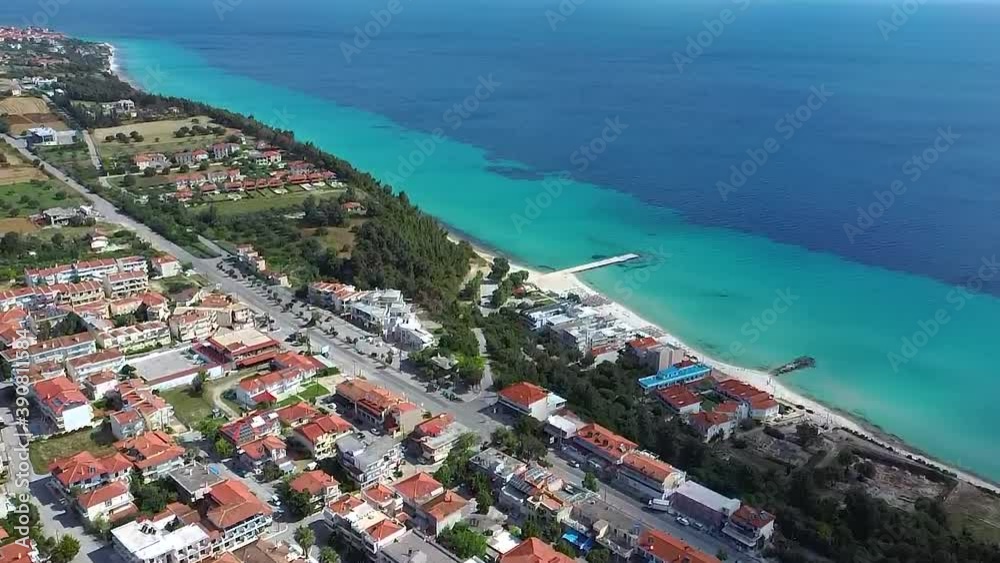 Aerial view of Idyllic beach with turquoise and blue water in the village of Kallithea in Halkidiki, Greece, bottom-up movement by drone Aerial view of Idyllic beach with turquoise and blue water in the village of Kallithea in Halkidiki, Greece, bottom-up movement by drone