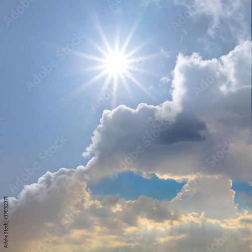 blue sky with cumulus clouds and sparkle sun, natural background