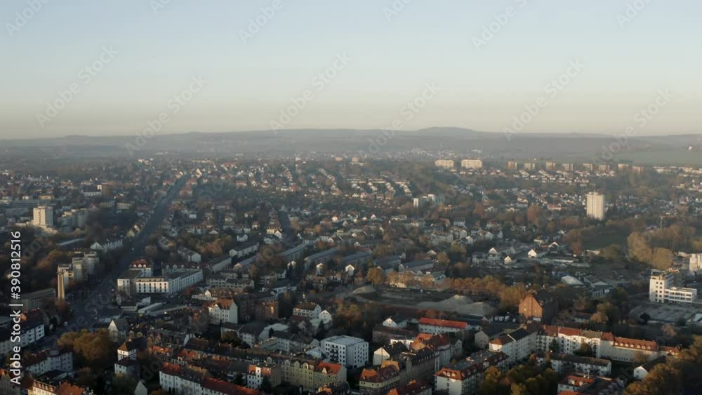 Drone shot of the cityscape landscape of Kassel in beautiuful soft sunlight and covered in fog. Typical german urban living, Germany, Europe. Drone shot of the cityscape landscape of Kassel in beautiuful soft sunlight and covered in fog. Typical german urban living, Germany, Europe.