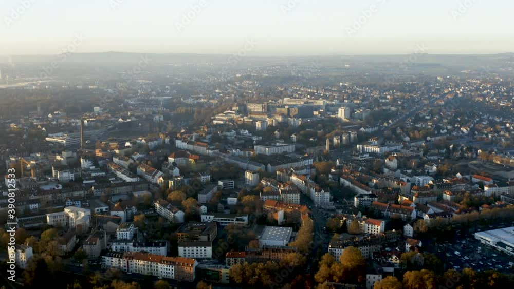 Drone shot of the cityscape landscape of Kassel in beautiuful soft sunlight and covered in fog. Typical german urban living, Germany, Europe. Drone shot of the cityscape landscape of Kassel in beautiuful soft sunlight and covered in fog. Typical german urban living, Germany, Europe.