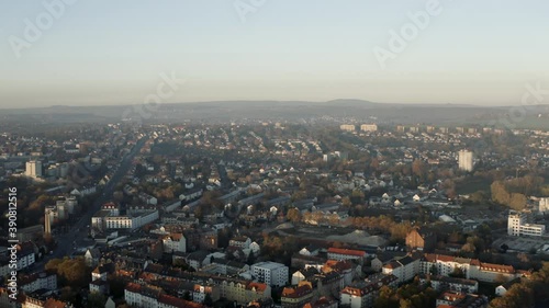 Drone shot of the cityscape landscape of Kassel in beautiuful soft sunlight and covered in fog. Typical german urban living, Germany, Europe. photo