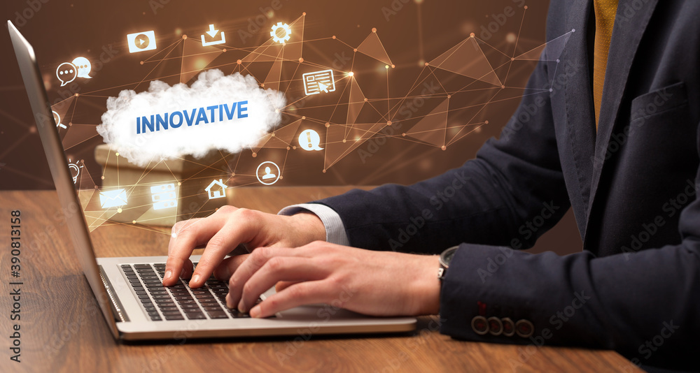 Businessman working on laptop with INNOVATIVE inscription, modern technology concept Businessman working on laptop with INNOVATIVE inscription, modern technology concept