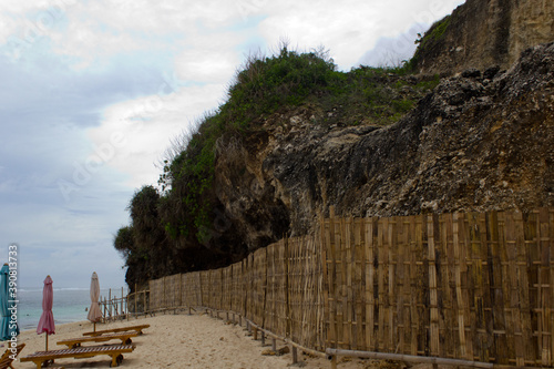 Hill which is restricted by wooden fence near the beach area