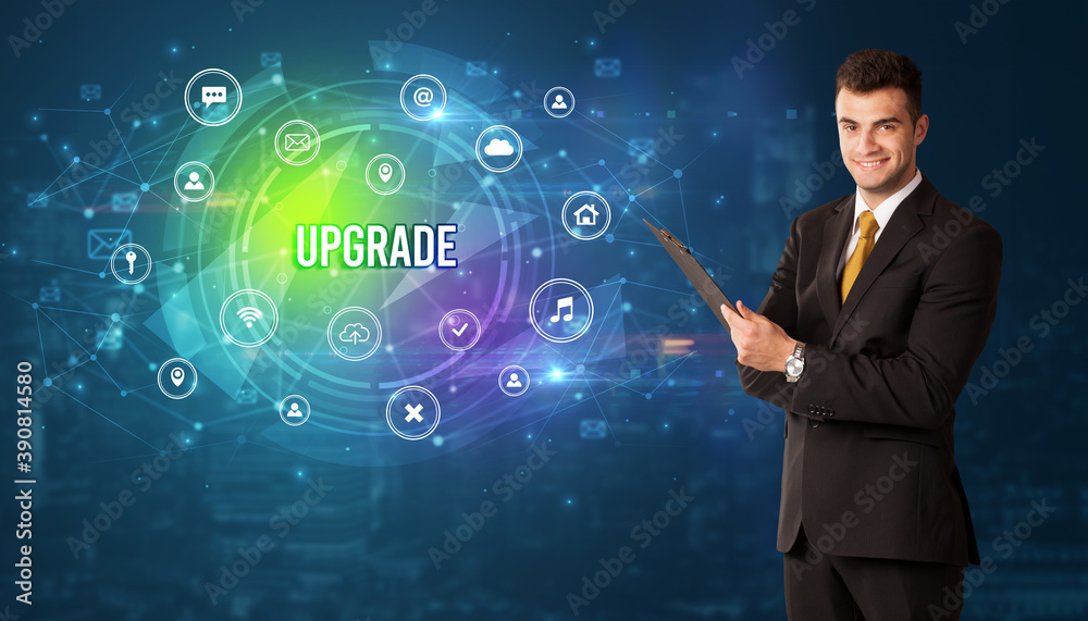 Businessman thinking in front of technology related icons and UPGRADE inscription, modern technology concept Businessman thinking in front of technology related icons and UPGRADE inscription, modern technology concept