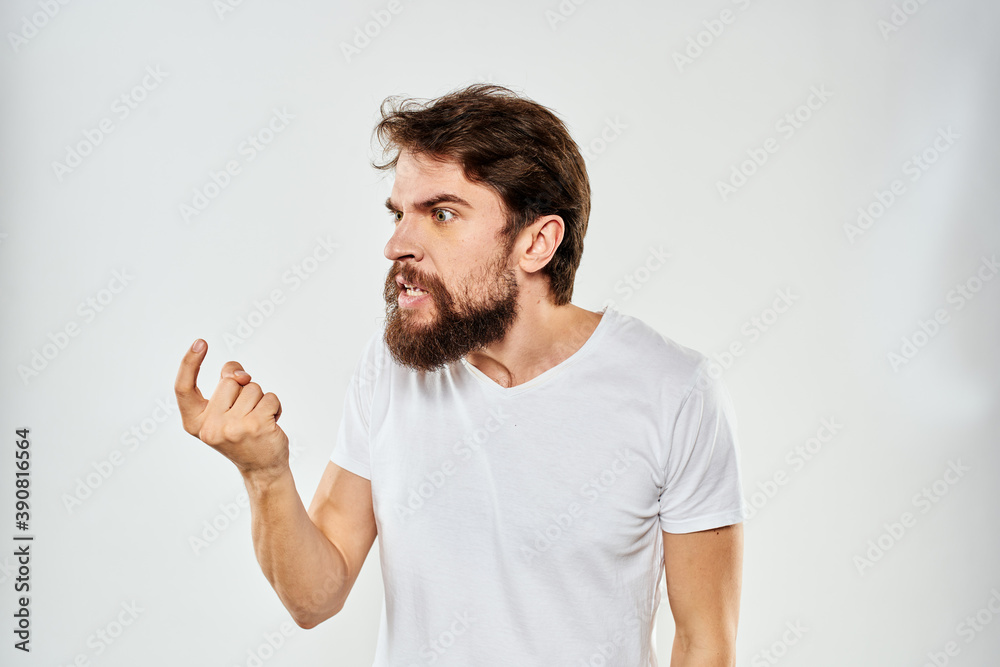 Fototapeta premium emotional man with a beard gesturing with his hands close-up studio aggression